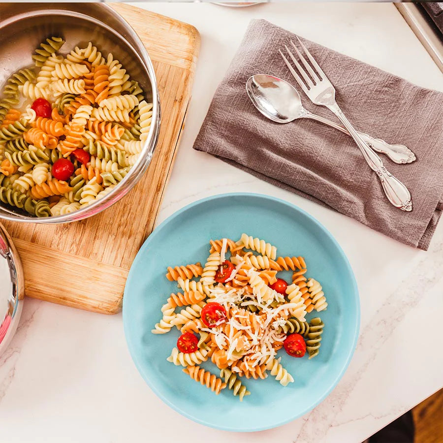 Toddler Bamboo plates holding pasta and dinner table
