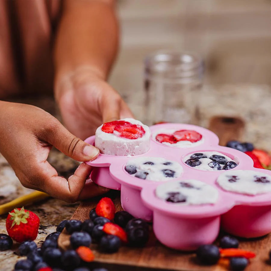 Large freezer tray with frozen smoothie and berries inside