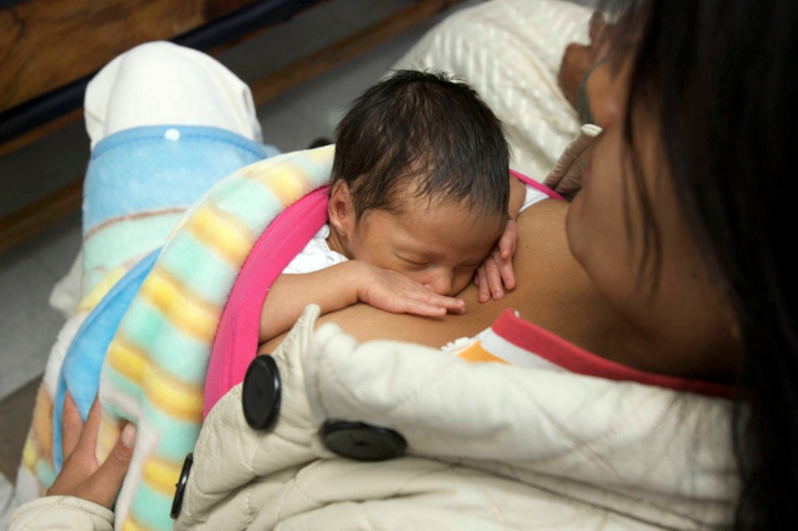 Mother with her baby on her chest