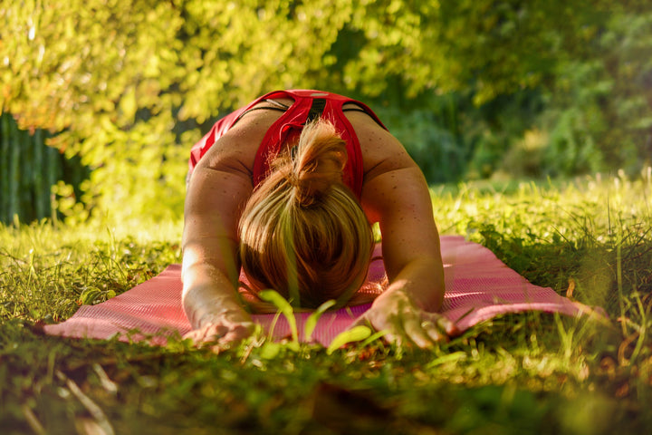 Woman doing a yoga pose self care