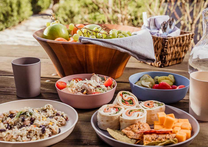 Plates, bowls, and cups laid out on a table to lunch