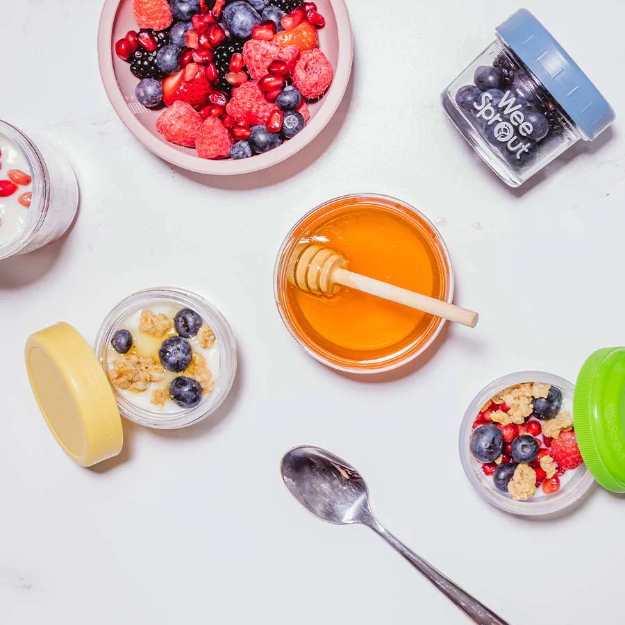 Various fruit and granola snacks sit on a table