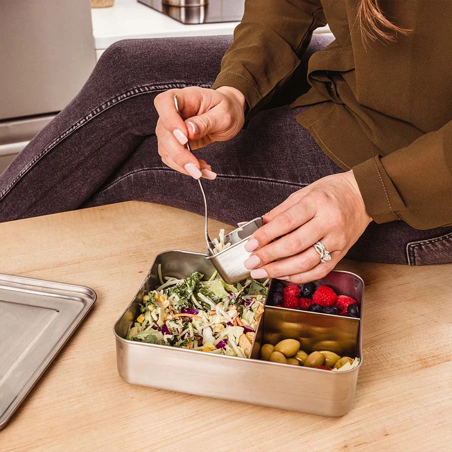 Mom eats lunch out of a stainless steel bento box