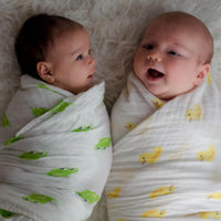 Two babies swaddled in the organic cotton swaddled blankets